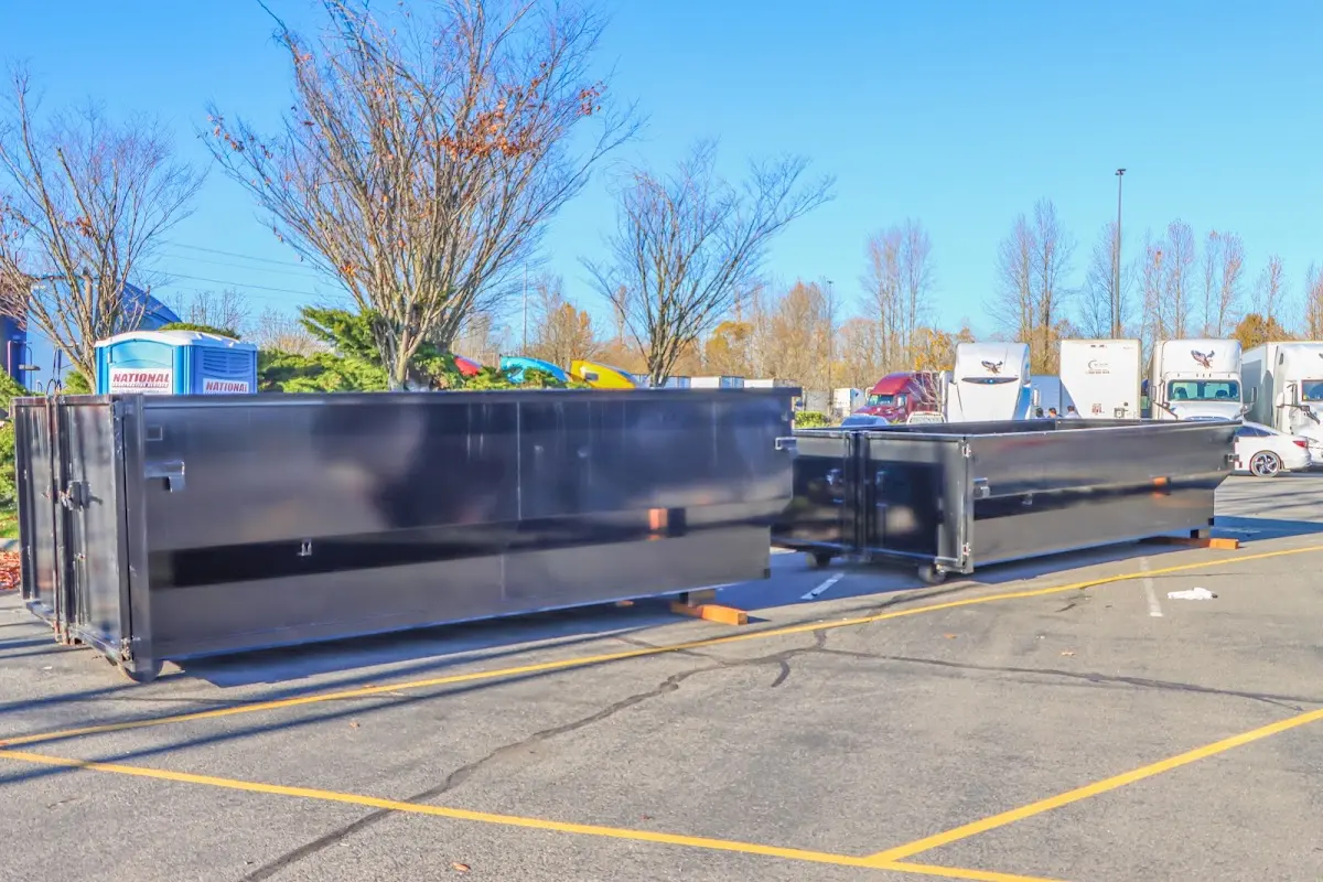 Professional dumpster rental service with roll-off container on residential driveway in Maumee